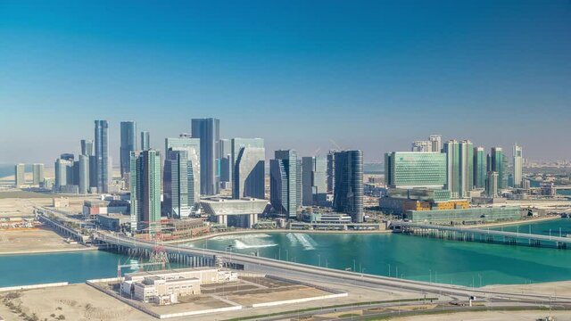 Aerial skyline of Abu Dhabi city centre from above timelapse before sunset with shadows from skyscrapers