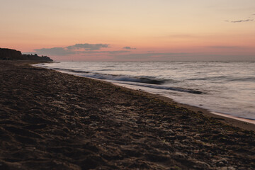 view of sunrise above the sandy sea beach