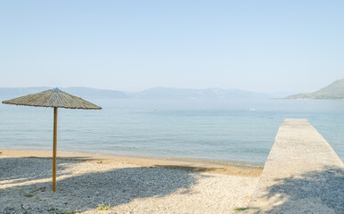 Reed umbrellas on the beach of the island of Evia-Greece 