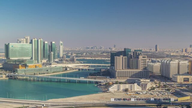Aerial skyline of Abu Dhabi city centre from above timelapse before sunset with shadows from skyscrapers