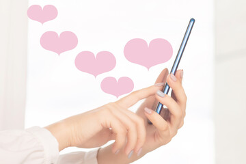 Happy Valentine's day, girl sends love hearts from smartphone