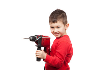 Portrait of happy little boy holding electric drill. A little construction worker. Isolated on white