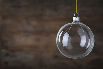 Transparent glass Christmas ball on blurred background. Space for text