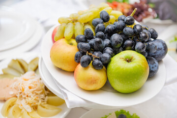 Naklejka na ściany i meble apples, grapes , plate of fruit on the table,