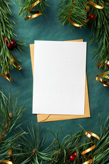 Christmas greeting card mockup with pine tree branches and golden tape on green background