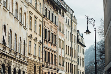 Group of historical buildings and a decorative street lamp along the street during sunny winter day in Budapest, Hungary. Facades of European houses
