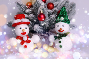 Cute snowmen and Christmas decoration on light background with snowflakes, bokeh effect