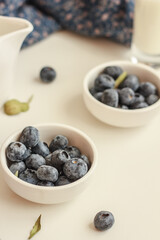 Fresh blueberries and milk on blue and white background. Healthy breakfast