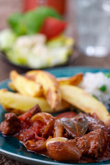 greek stifado meat stew with fries