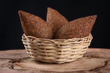 Kibe roast in basket with black background.