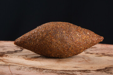 Kibe roast on the wooden table with black background.