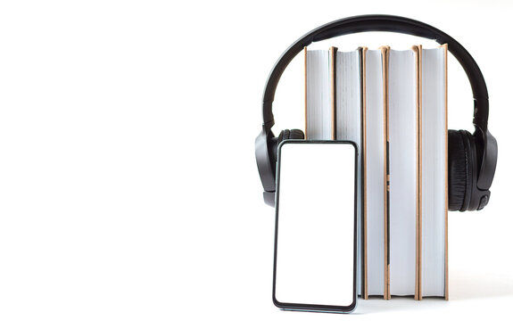 headphones, phone and books on a white background. Audiobook concept