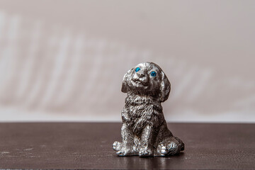 Figure of a cute dog on a blurred background. Concept of waiting and hope.