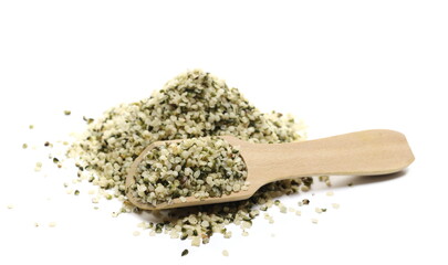 Peeled hemp seed in wooden spoon isolated on white background