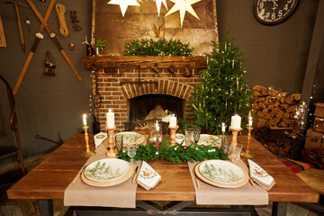 Home Christmas decoration interior late in night with light on xmas tree and fireplace.