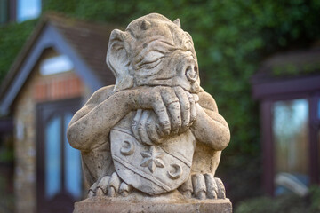 Fototapeta premium A sleepy gargoyle guards a historic house in England