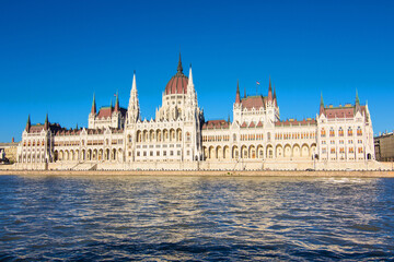Fototapeta premium Hungarian National Parliament Building on the bank of the Danube river in Budapest, capital of Hungary. Hungarian landmark and a popular tourist destination in Budapest. Designed in neo-Gothic style