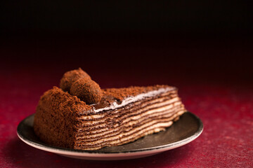 chocolate cake on a burgundy background