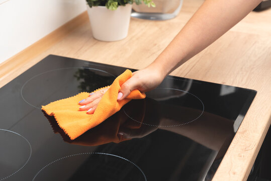 Woman Cleaning Induction Stove