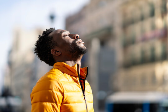 African Man Breathing Fresh Air Outdoors Standing In The City