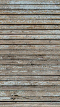 Weathered wooden wall with exfoliated light gray paint. Vertical texture of old painted wood for mobile phone wallpaper or background. Empty template for design, copy space