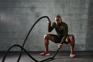 Man doing battle rope training exercises