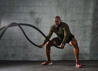 Man doing battle rope training exercises