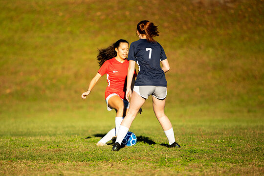 Young girls playing soccer scrimmage game
