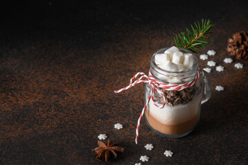 Edible Christmas gift in mason jar gift for cooking hot chocolate on brown. Close up.