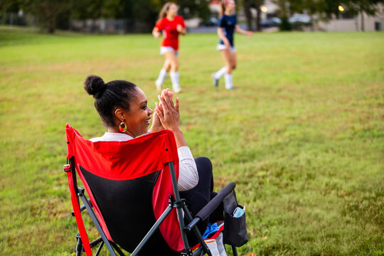 Supportive mother cheers for daughters' team