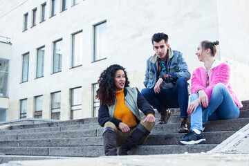 Fototapeta premium cute group of teenages at the building of university with books huggings, diversity nations real students lifestyle