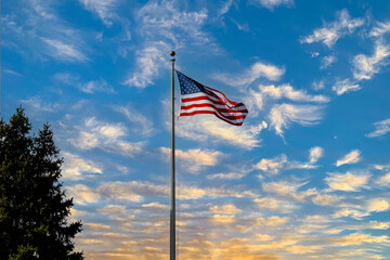american flag waving in blue sky