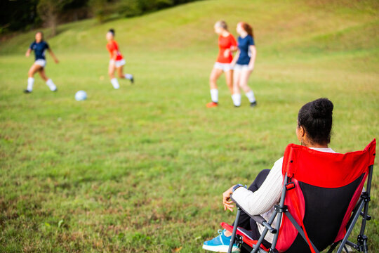 Supportive Mom Watches Daughters Play Soccer