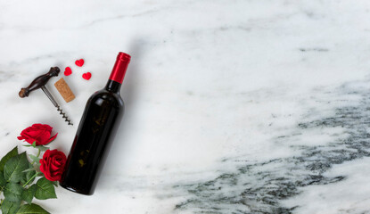 Happy Valentines Day with lovely red rose flowers and red wine bottle plus hearts on natural marble stone