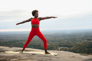 Black woman doing yoga at park