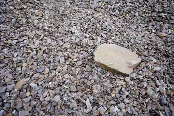 Large rock sitting on pile of smaller rocks