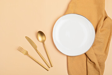 Empty white plate and cotton napkin on pink backdrop. Food background for menu, recipe book. Table setting. Flatlay, top view