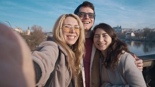 Happy friends taking selfe in Prague. Travel, friendship, youth, millenial, blogger, fame social media concept. Filmed on REd 4k, 10 bit color
