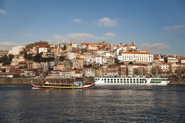 Porto Portugal Douru river view from the other side  sunny day blue sky with white clouds boats old city