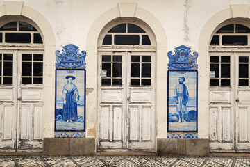 Fototapeta na wymiar facade of an house building old doors wall painting blue of people traditional art Portugal Aveiro 