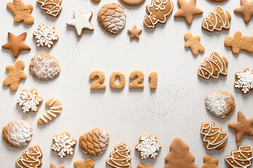 Christmas handmade cookies arranged around date 2021 on white background. Merry Christmas. View from above. Flat lay.