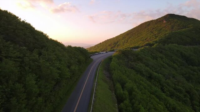 Aerial over the Blue Ridge parkway and mountains at sunset near Asheville, North Carolina.