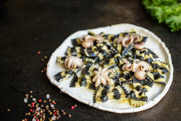 pasta ink cuttlefish seafood farfalle with baby octopus small octopuses second cours on the table meal snack ingredient top view copy space for text food background rustic
