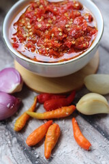 Sambal Bawang Or Spicy Onion Sauce with ingredients, Onion, Red Chilies, garlic, and salt. 