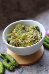 Sambal ijo Or Green chili sauce with ingredients, Greem chilies, onion, garlic, and salt 