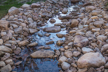 A stream through a rock bed in the evening