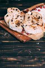 Christmas fruit cake with sugar powder on marble board. Wooden table and copy space for your text