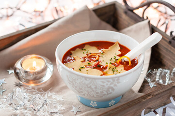 Christmas Tomato Soup with Ornament Shaped Pasta. Winter Decoration.