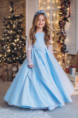 Little cute happy adorable girl in elegant fashion dress in christmas decorations. Christmas holidays, celebaration concept