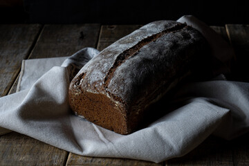Freshly baked grain oats brown bread close up photos. Gastronomic photography.
Dark food  photography